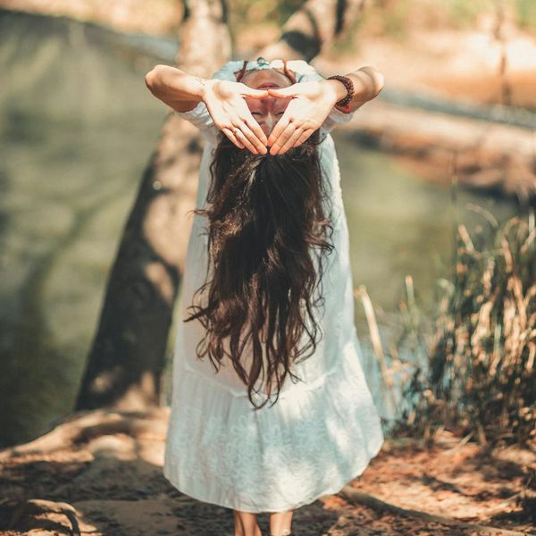 Person meditating calmly in a natural environment.