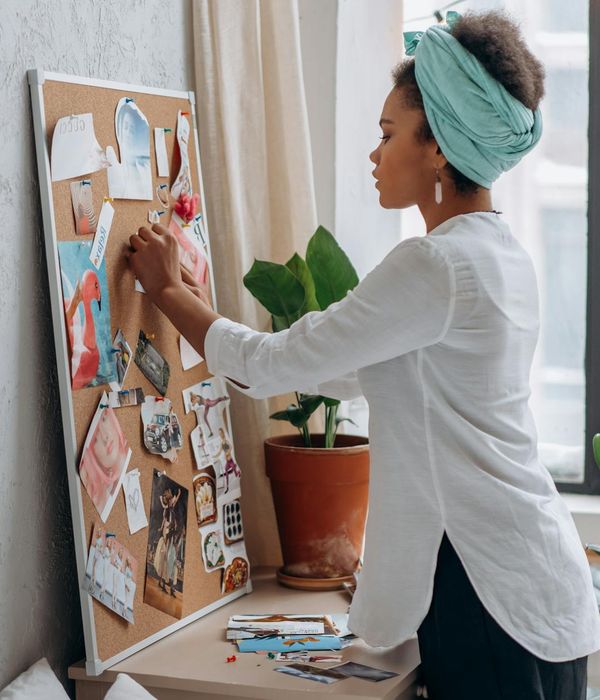 Woman in a peaceful yoga pose in a dark room with honey glow.